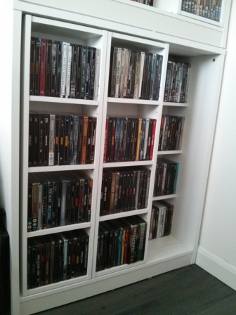 224 Steelbooks front and behind, some DVDs on top shelf behind