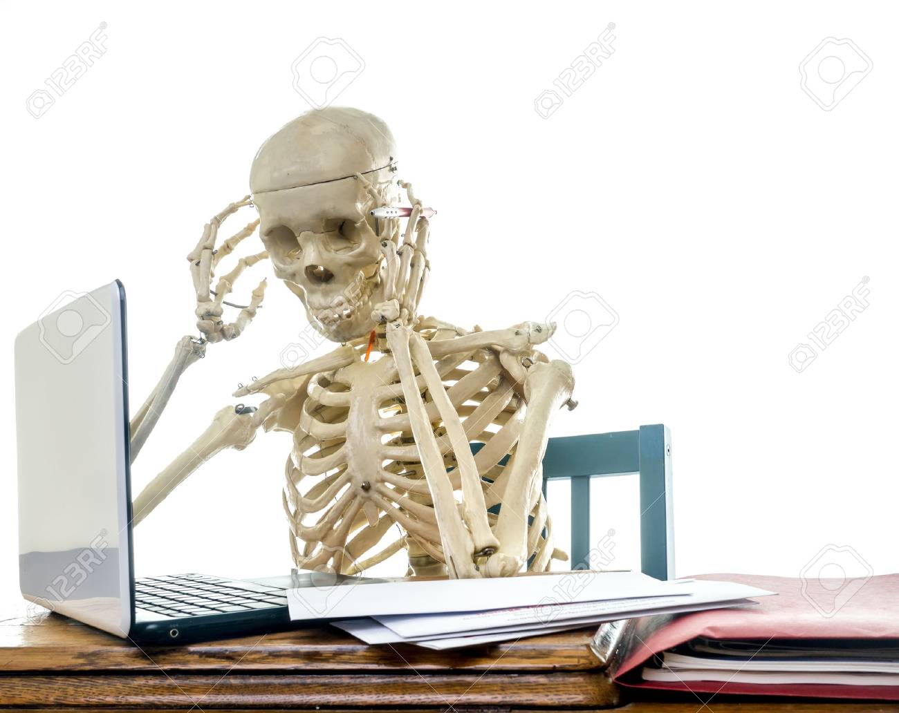 15013098-a-skeleton-getting-a-headache-from-paying-bills-computer.jpg